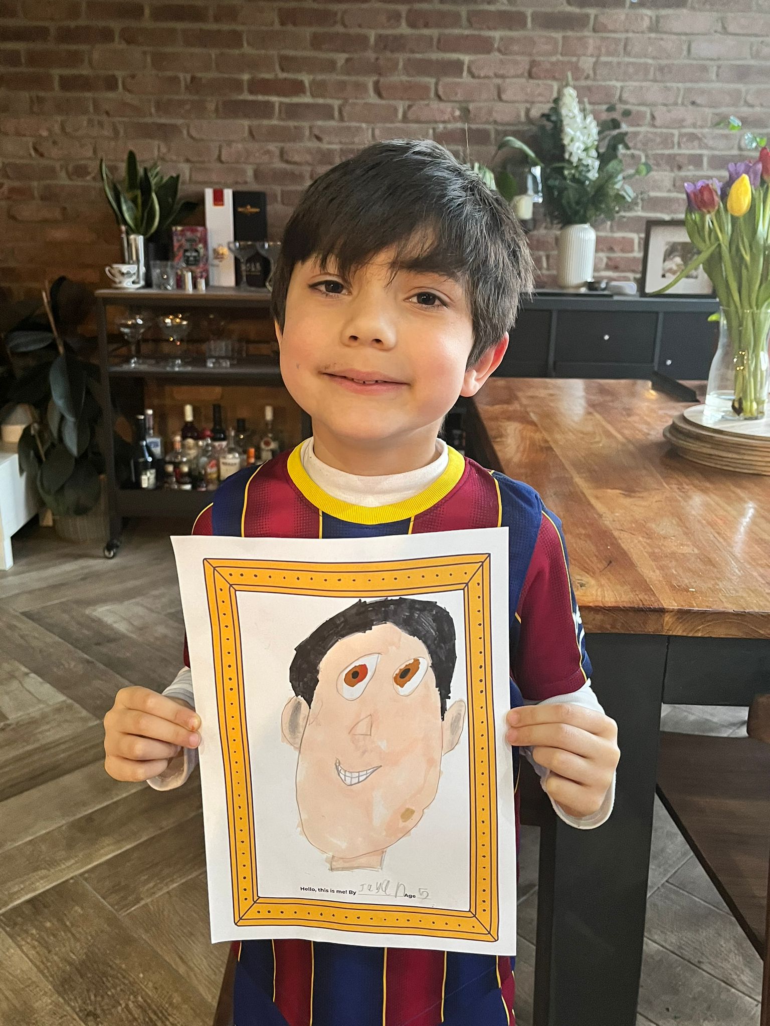 A boy holding a drawing