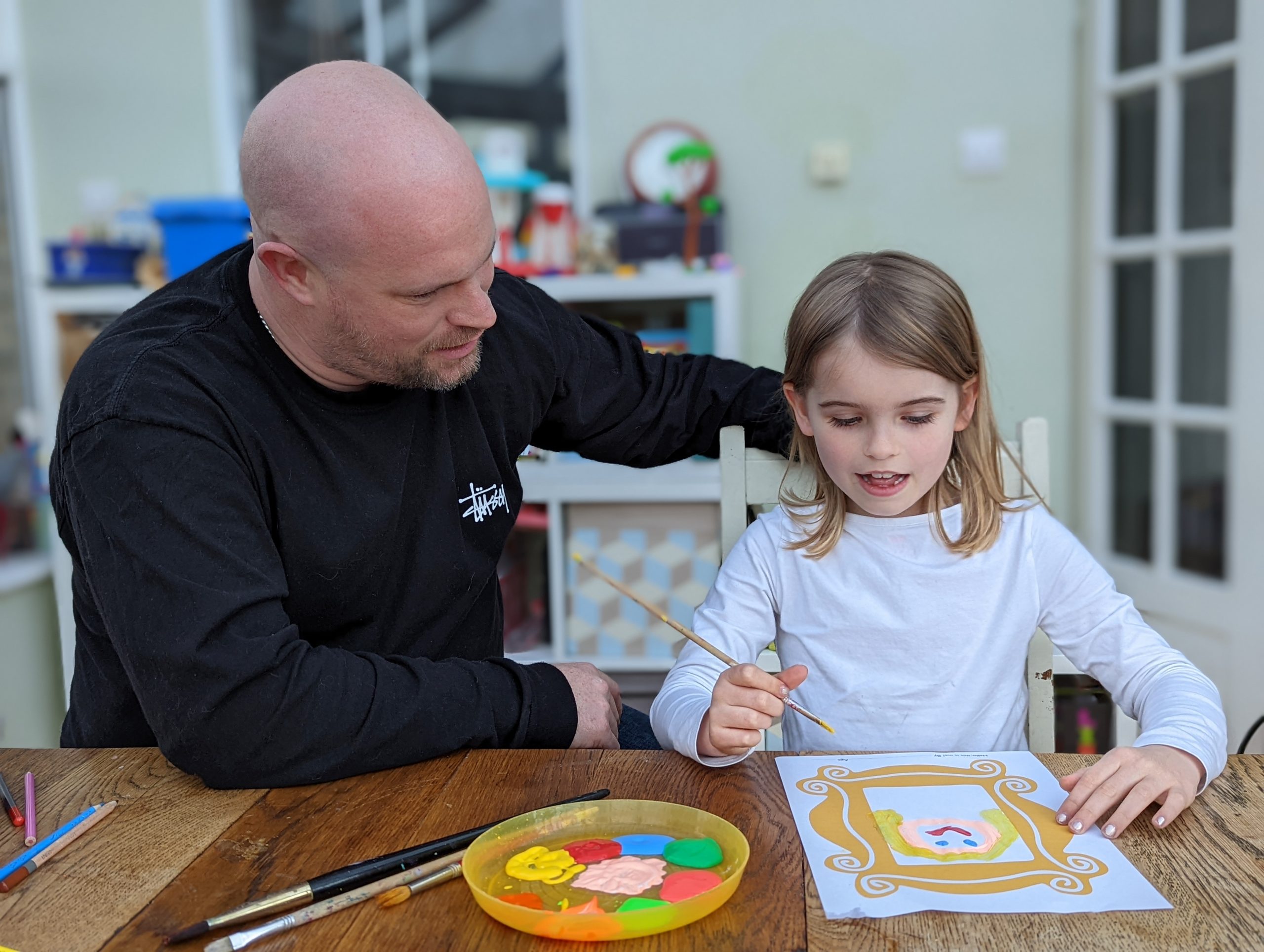 A father and daughter painting